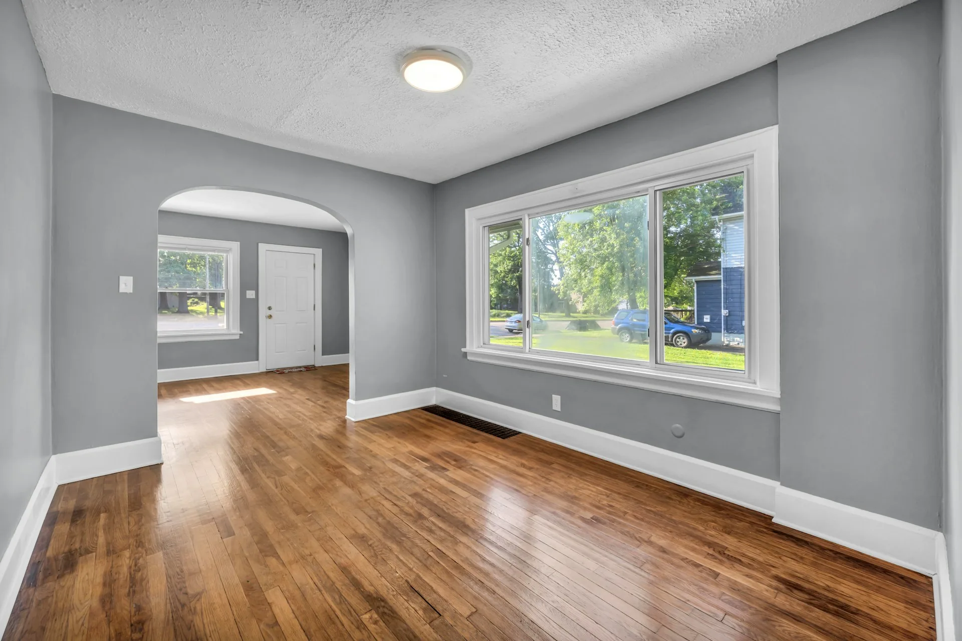 Empty room with a warm hardwood floor
