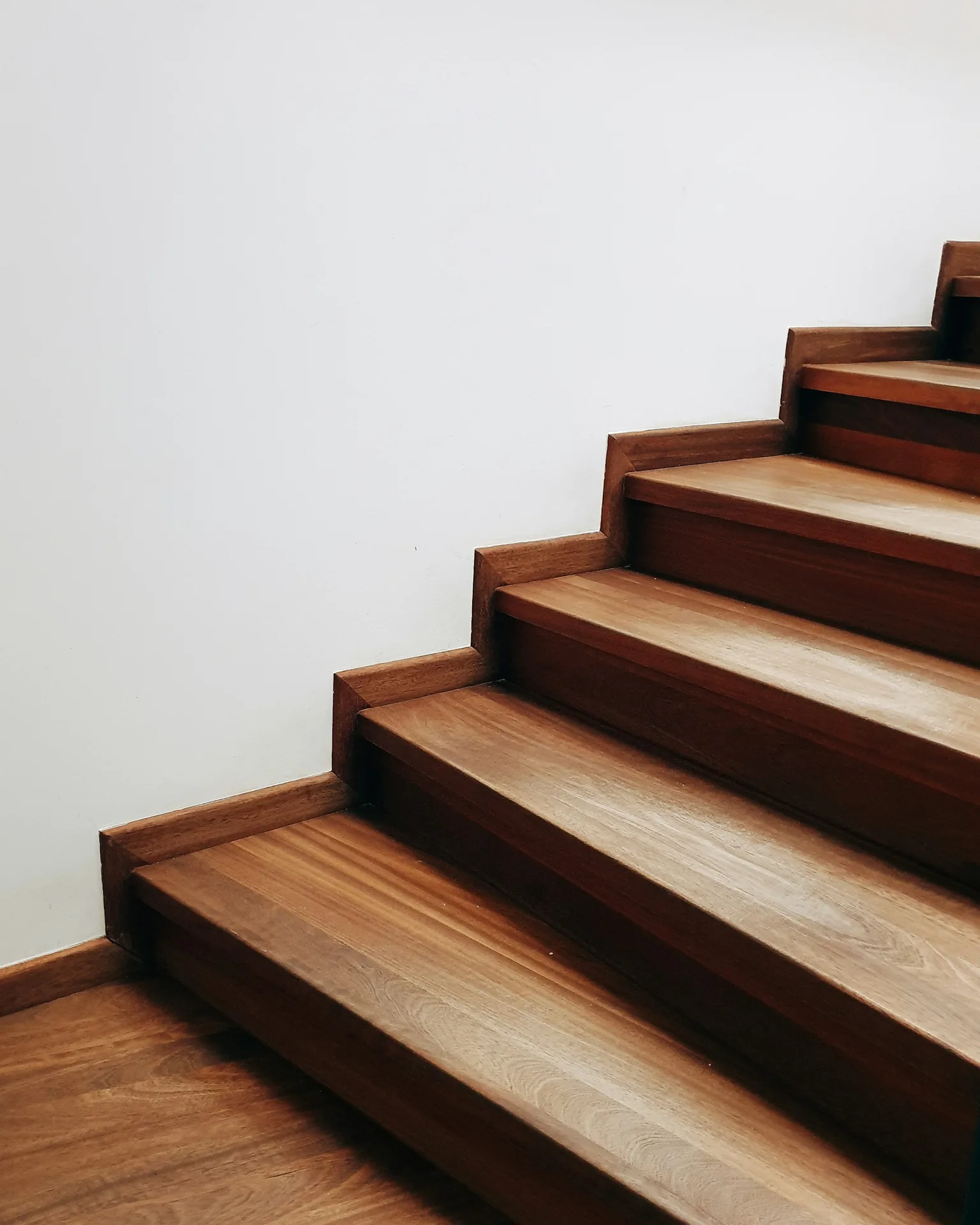 Wood stair treads against a white wall